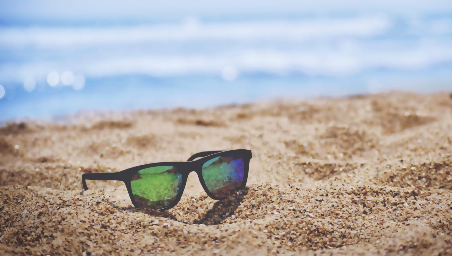 sunglasses on sandy beach