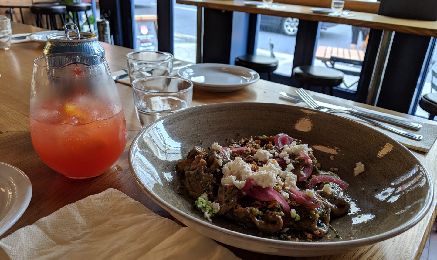 bowl of pasta with orange drink in background, cincin hove