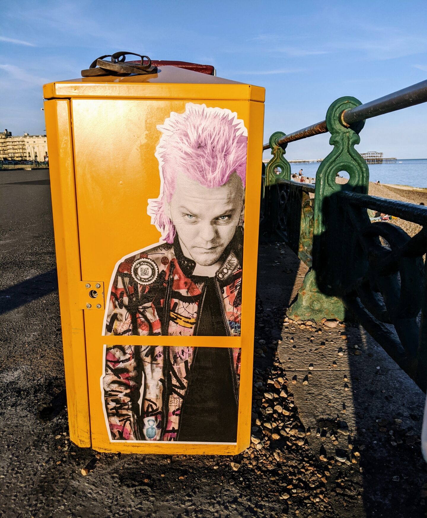 yellow bbq bin with image on it along hove seafront